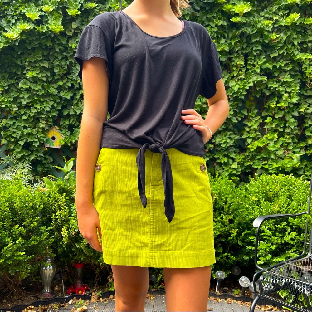 Kim and Cami M black top with short sleeves and a knot on the bottom.
